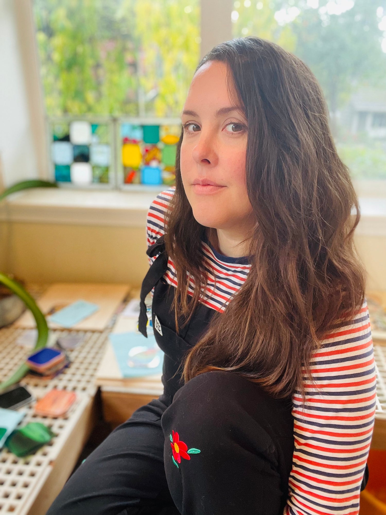 Stained glass artist Korina Oswald in her studio