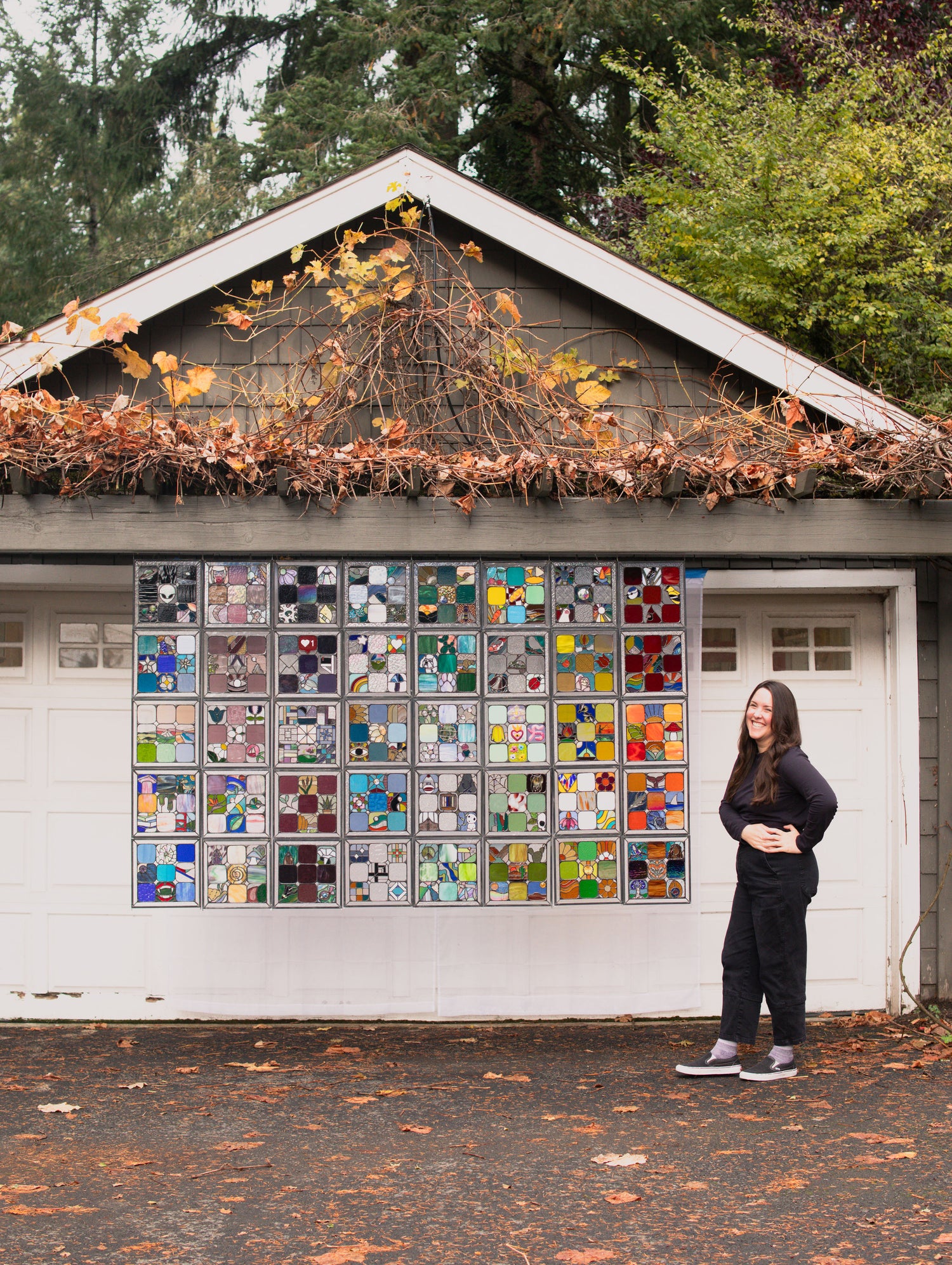 Stained Glass quilt blanket hung on a garage to see the scale with artist Korina Oswald