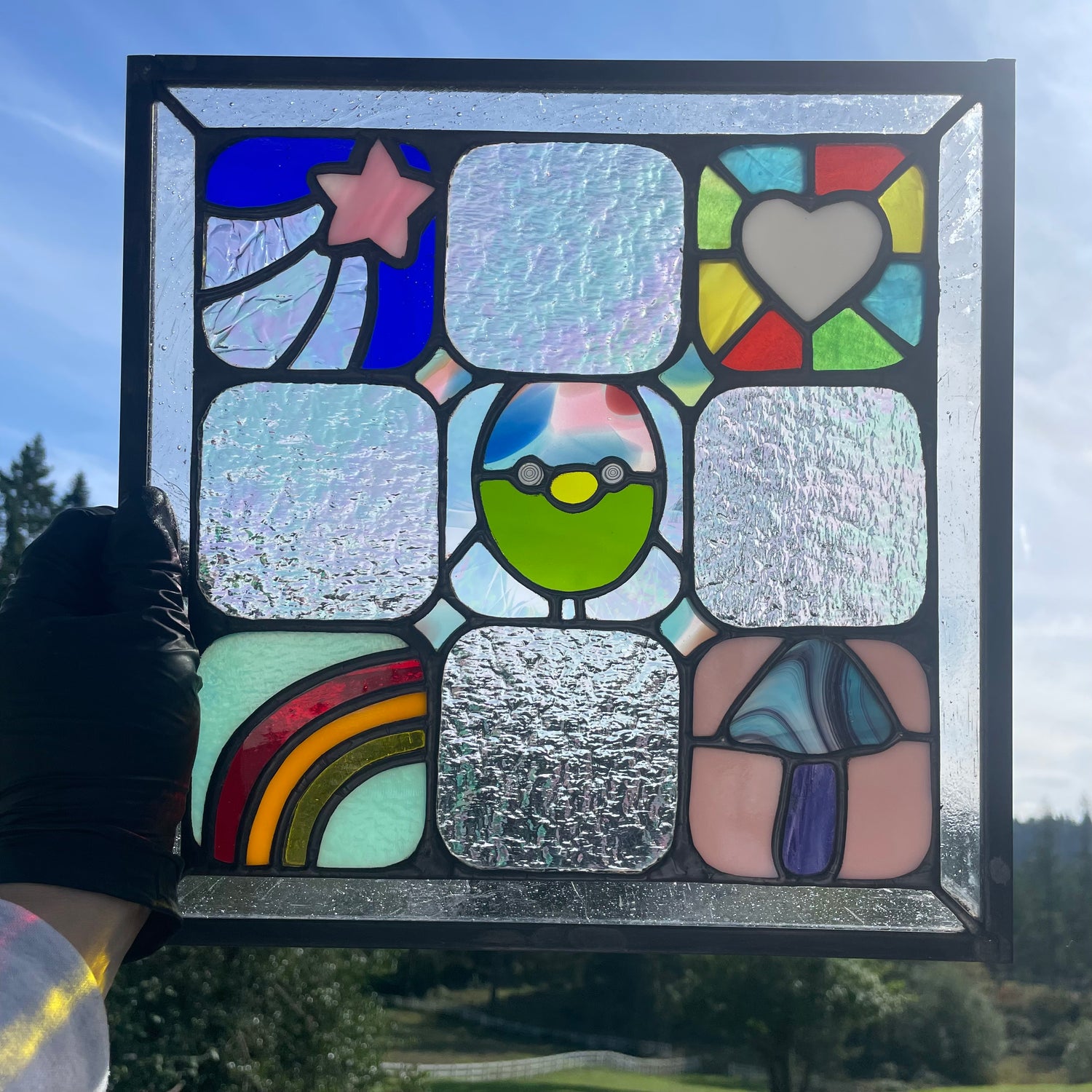 One quilt panel assembled by stained glass artist with multiple other artists mini panels